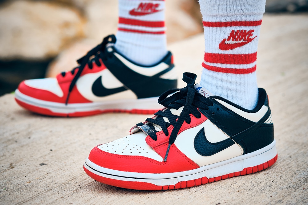 On-feet Nike Dunk Low EMB NBA 75th Anniversary Chicago colorway sneakers illustrative editorial